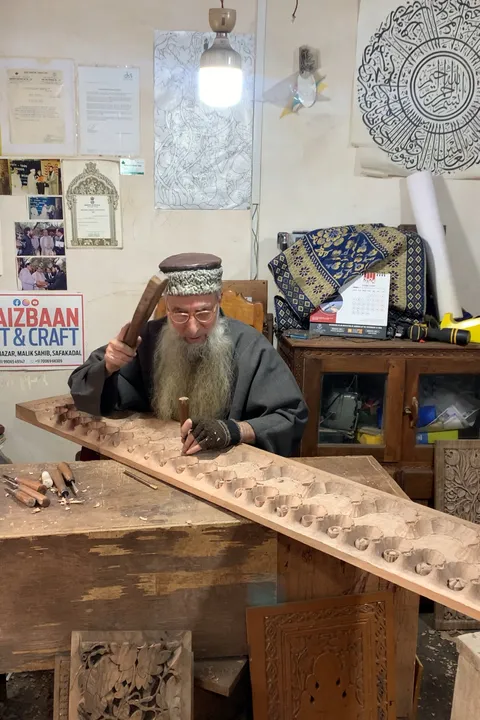  A wood carving artisan at work in Kashmir 