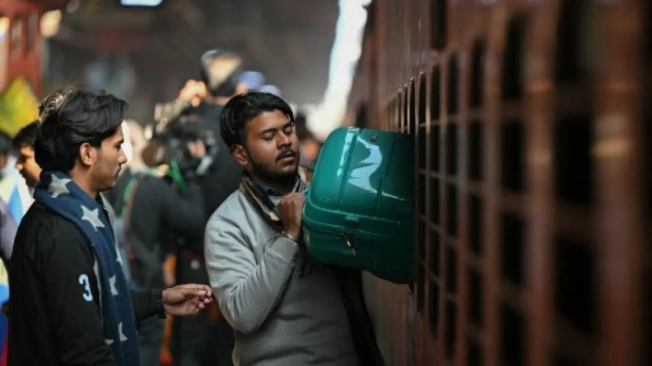  Passengers take out their luggage from the emergency exit window of a train carriage at the New Delhi railway station in New Delhi on February 16, 2025. Photograph: (AFP) 