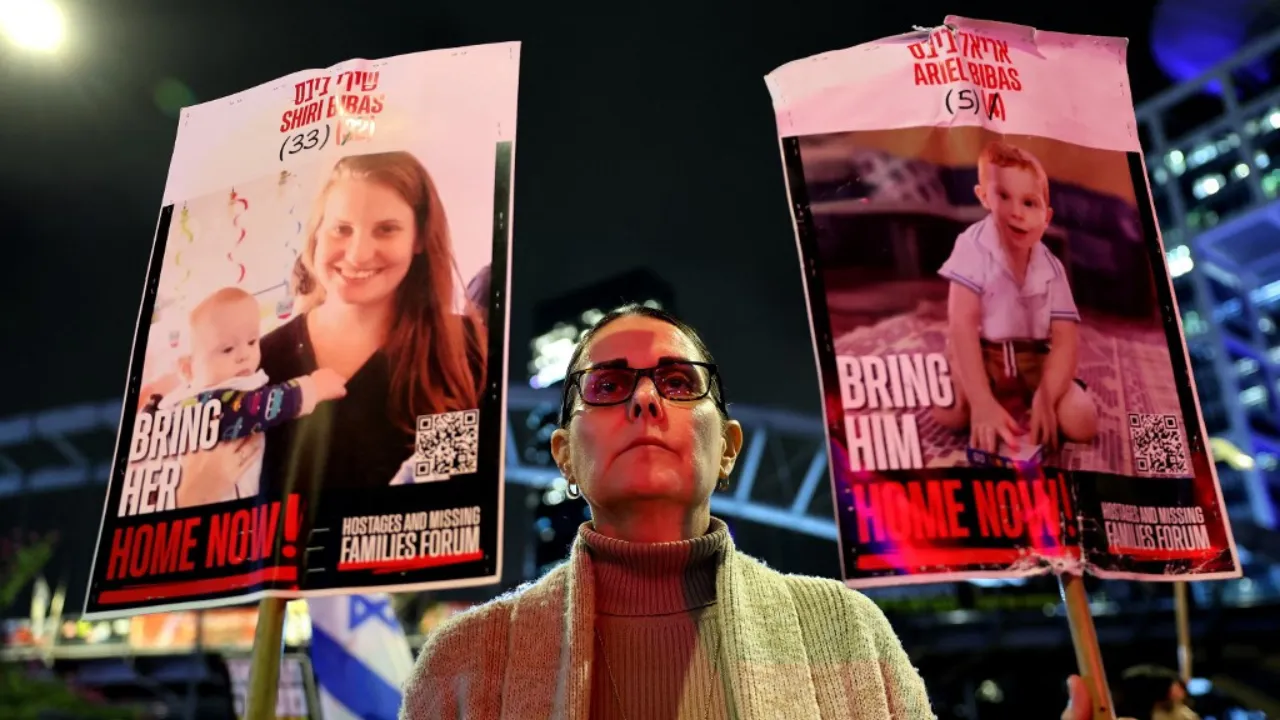  A demonstrator holds placards bearing pictures of members of the Bibas family, during a protest calling for the release of hostages held captive in Gaza since the October 7, 2023 attack by Palestinian Hamas militants, in front of the Israeli defence ministry in Tel Aviv on February 19, 2025.  Photograph: (AFP) 