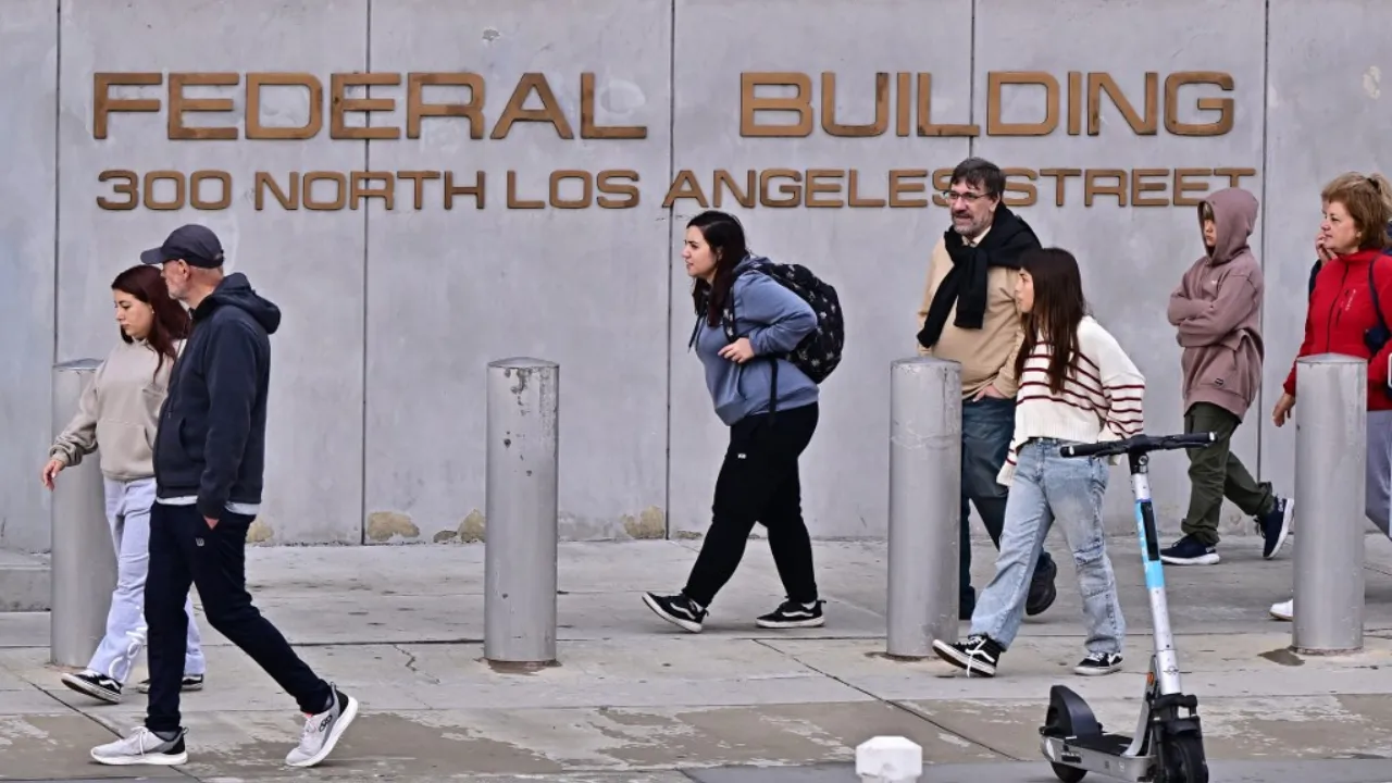  File Photo: Pedestrians walk past the Federal Building in Los Angeles, California, on February 14, 2025.  Photograph: (AFP) 