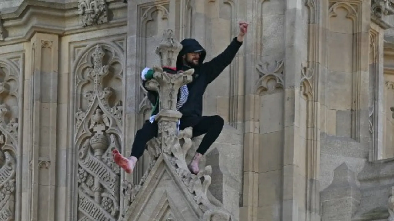 A protester holding a Palestinian flag gestures from the side of the Elizabeth Tower, commonly known by the name of the clock's bell "Big Ben", at the Palace of Westminster, home to the Houses of Parliament, in central London, on March 8, 2025. Photograph: (AFP) 