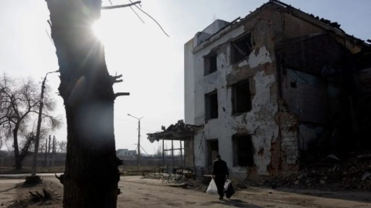  A man surrounded by stray dogs walks down the street near a damaged building in Kostyantynivka, Donetsk region, on March 11, 2025, amid the Russian invasion of Ukraine. Photograph: (AFP) 