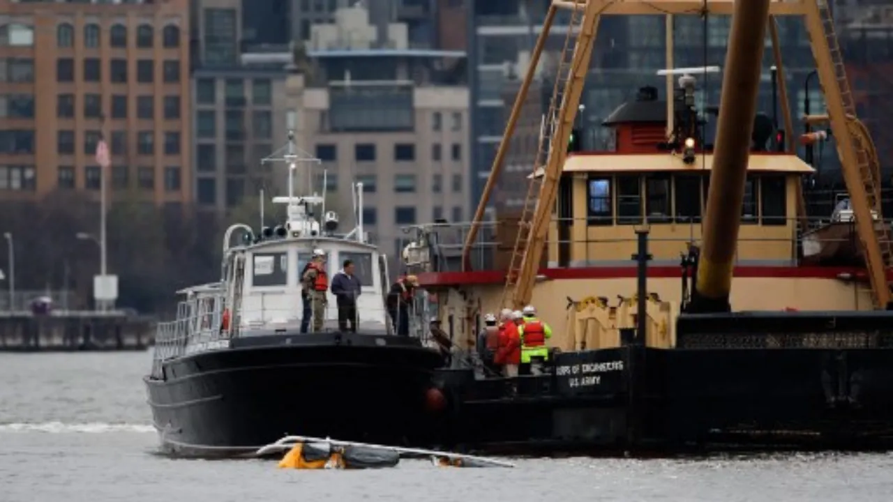  First responders are seen near the landing skids of a helicopter after it crashed into the Hudson River, in the Newport neighborhood of Jersey City, New Jersey, on April 10, 2025. Photograph: (AFP) 