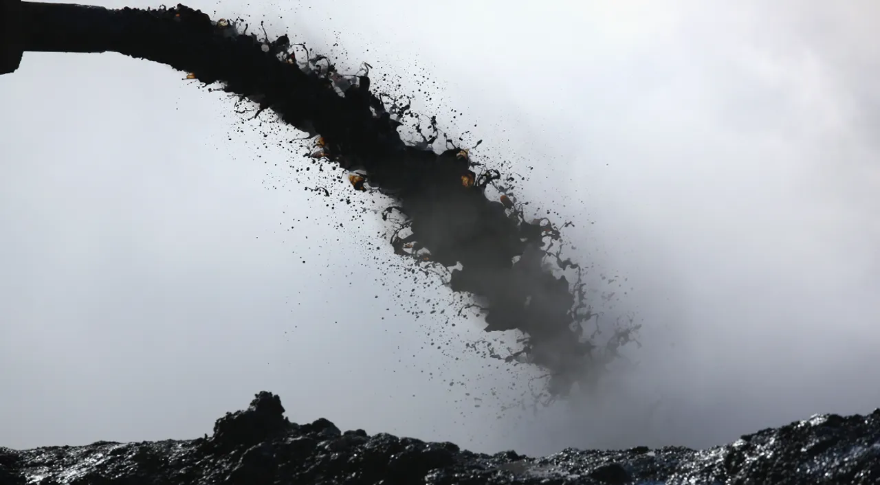  Smoking oil dregs are dumped into the ground in Syria's Derik. Photograph:(Getty) 