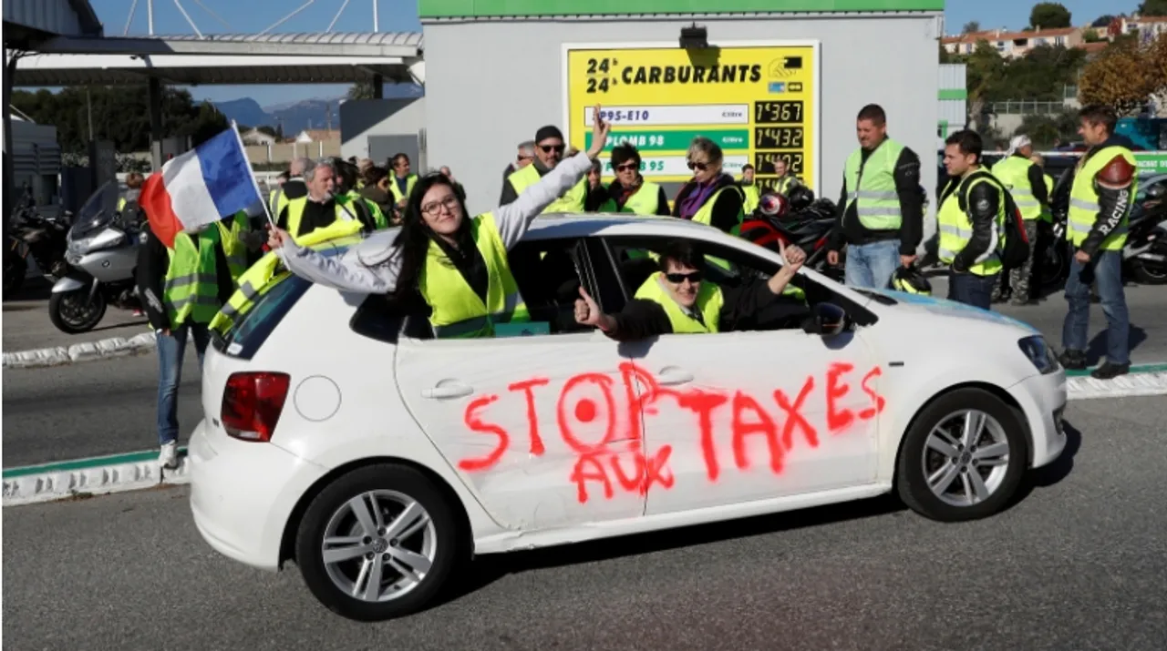  People wearing yellow vests, a symbol of a French drivers' protest against higher fuel prices, demonstrate near a petrol station in Antibes, France. Photograph:(Reuters) 