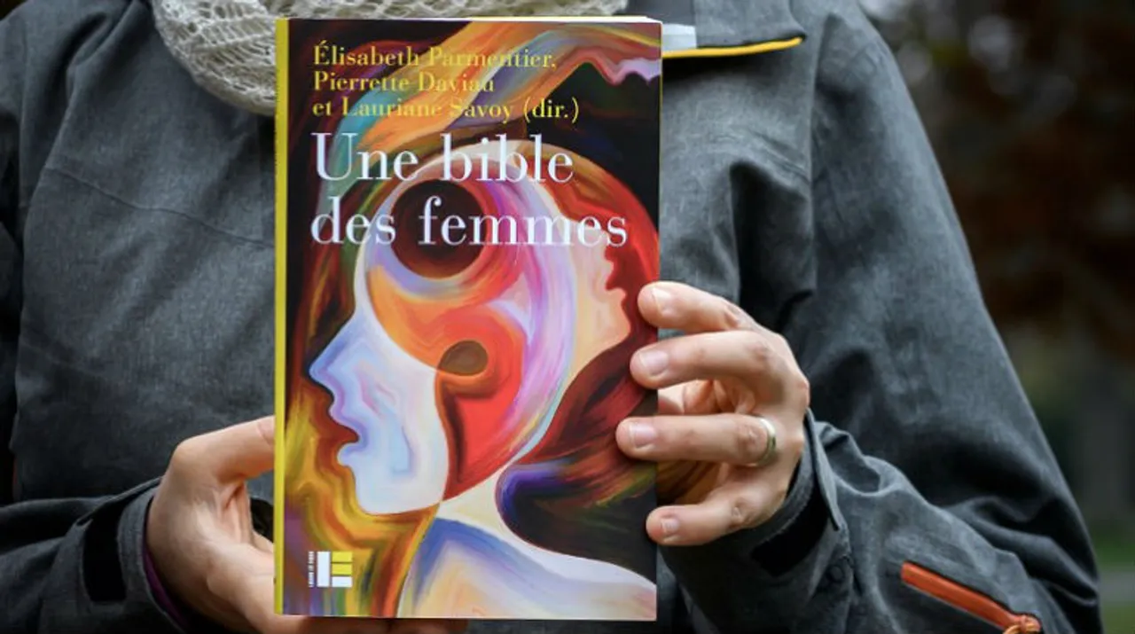  Theology professor Lauriane Savoy holds an edition of "A Women's Bible" in Geneva. Photograph:(AFP) 