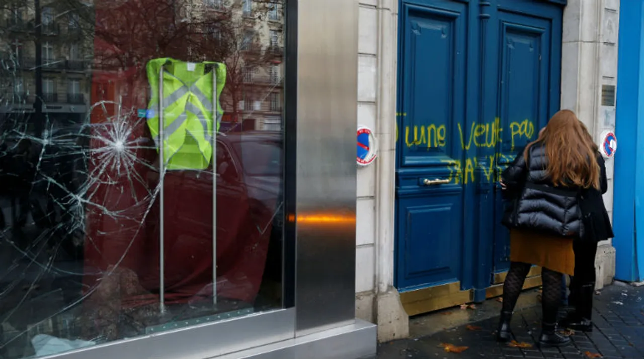   A yellow vest hangs inside a vandalised store the morning after clashes with protesters wearing yellow vests, a symbol of a French drivers' protest against higher diesel taxes. Photograph:(Reuters) 