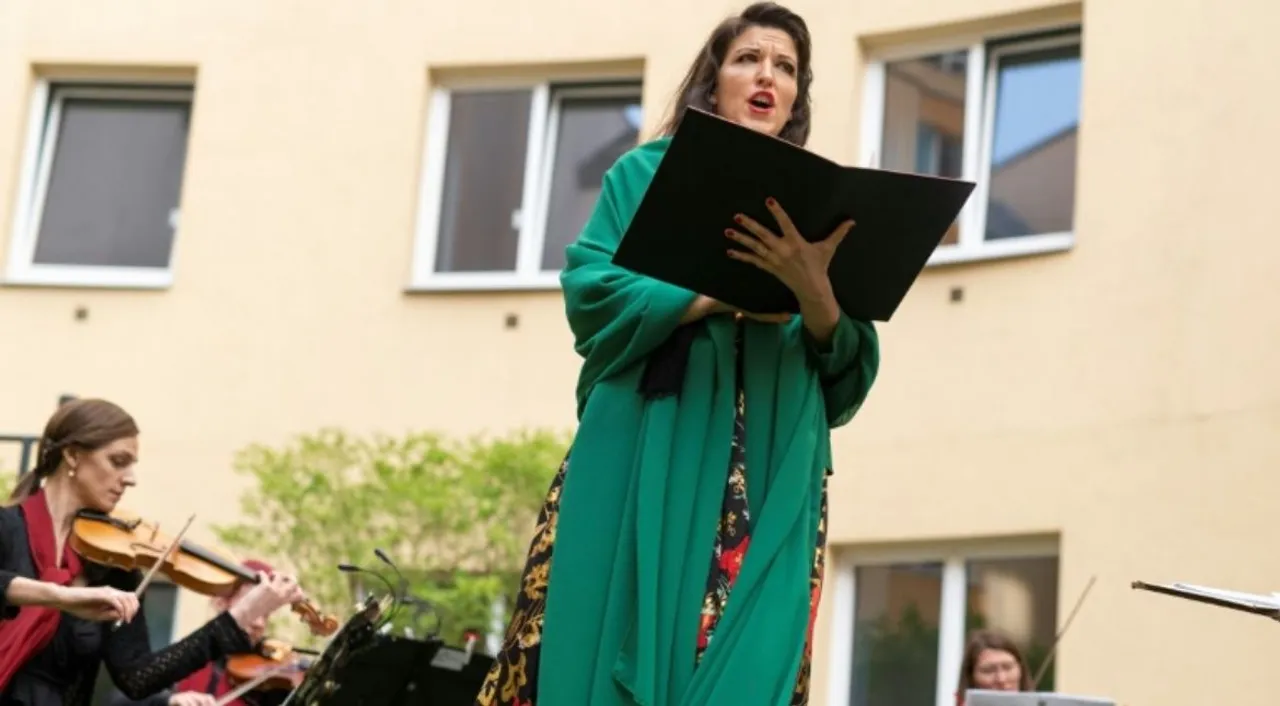  Monika Medek and the Camerata Carnuntum orchestra perform for guests during the 'window concert' at the Vienna hotel Photograph:(AFP) 