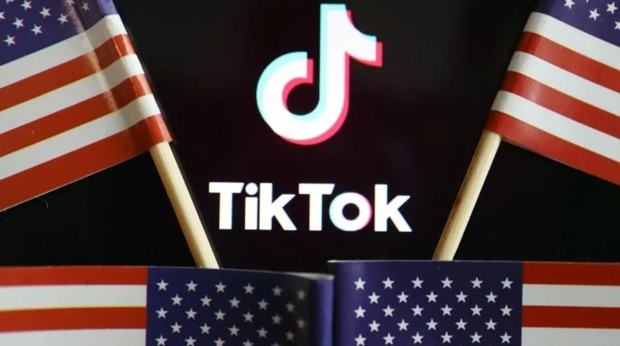  US flags are seen near a TikTok logo in this illustration picture Photograph:(Reuters) 