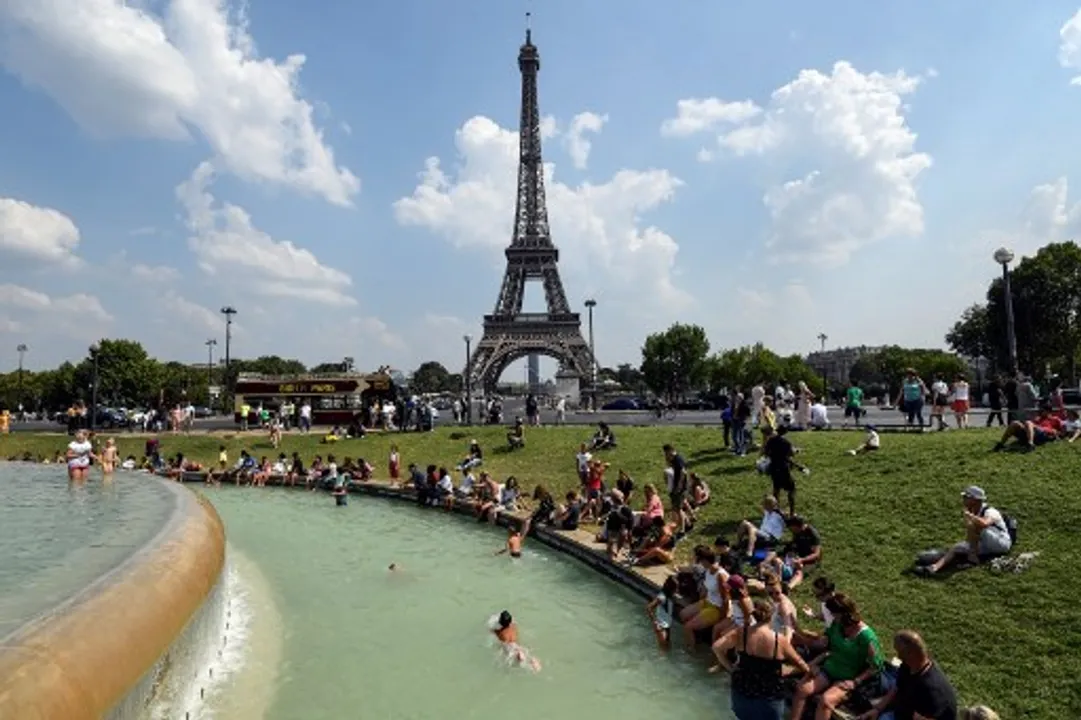  People cool themselves at the Fontaine du Trocadero in front of The Eiffel Tower in Paris  Photograph:(AFP) 