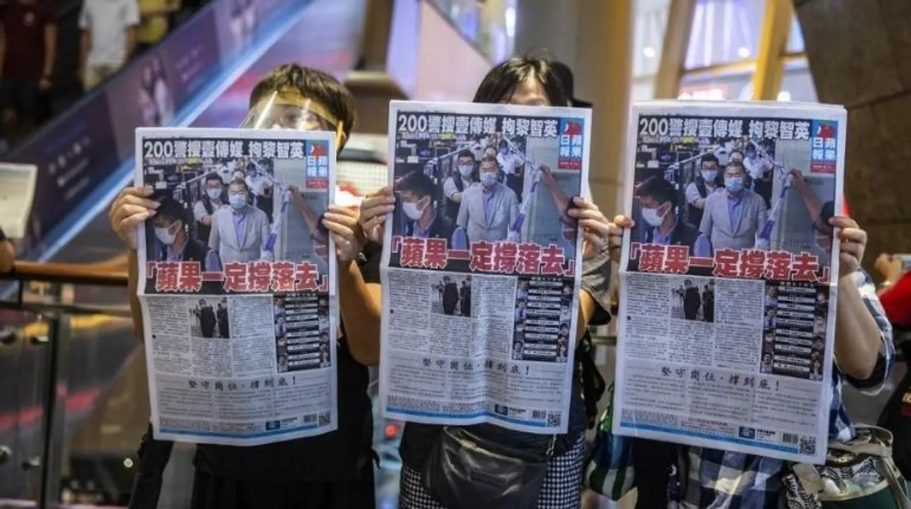  People hold up copies of the Apple Daily as they protest for press freedom inside a mall in Hong Kong on August 11, 2020, a day after authorities conducted a search of the newspaper's headquarters after the company's founder Jimmy Lai was arrested under the new national security law. Photograph:(AFP) 