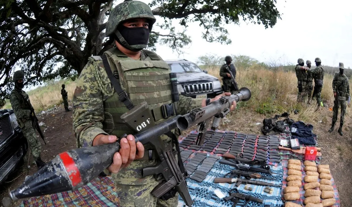  A soldier holds up a seized grenade launcher after an operation at the village of Guayabal outside Veracruz Photograph:(Reuters) 