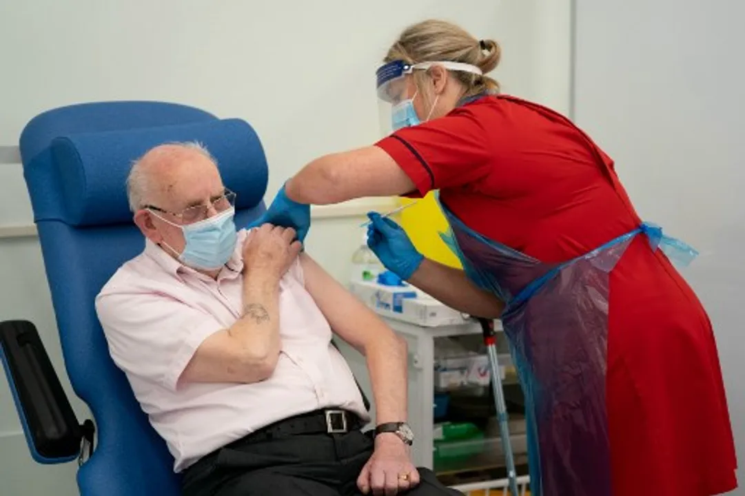  George Dyer, 90, reacts as he receives a dose of the Pfizer/BioNTech Covid-19 vaccine at Croydon University Hospital in south London Photograph:(AFP) 