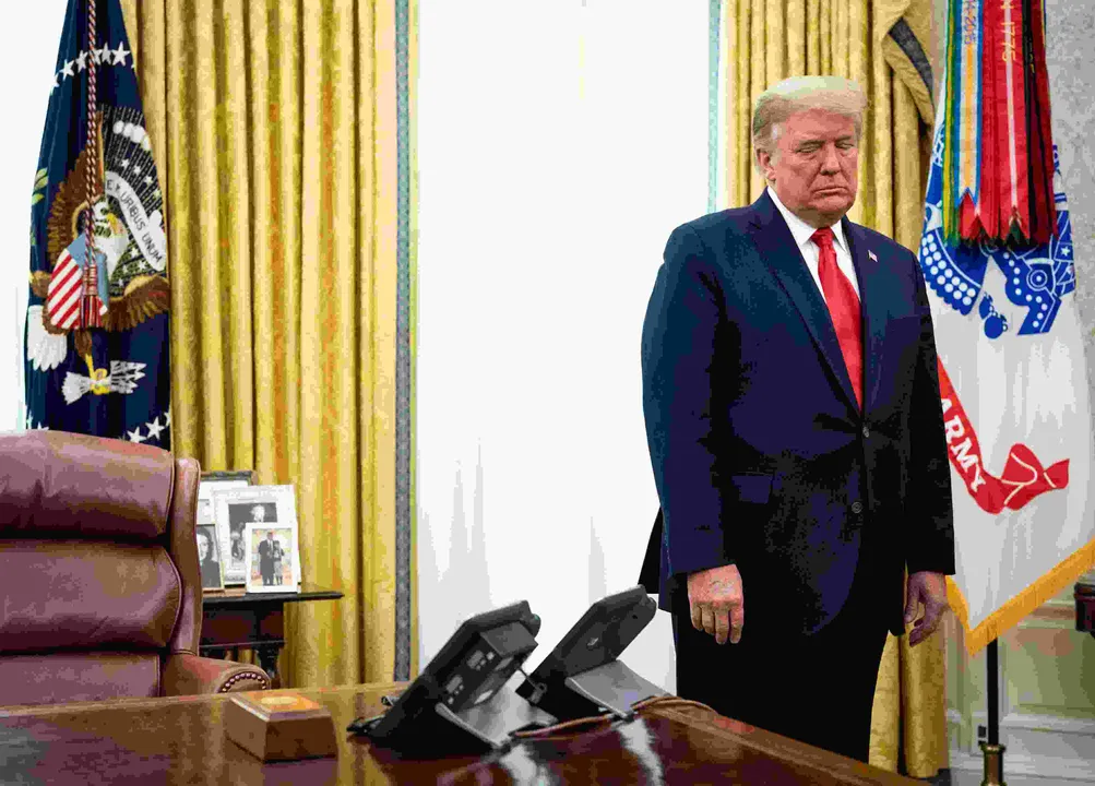  President Donald Trump stands by his desk during a Medal of Freedom presentation for the former football coach Lou Holtz, at the White House in Washington, Dec, 3, 2020. (Doug Mills Â© 2020 The New York Times Company) Photograph:(The New York Times) 