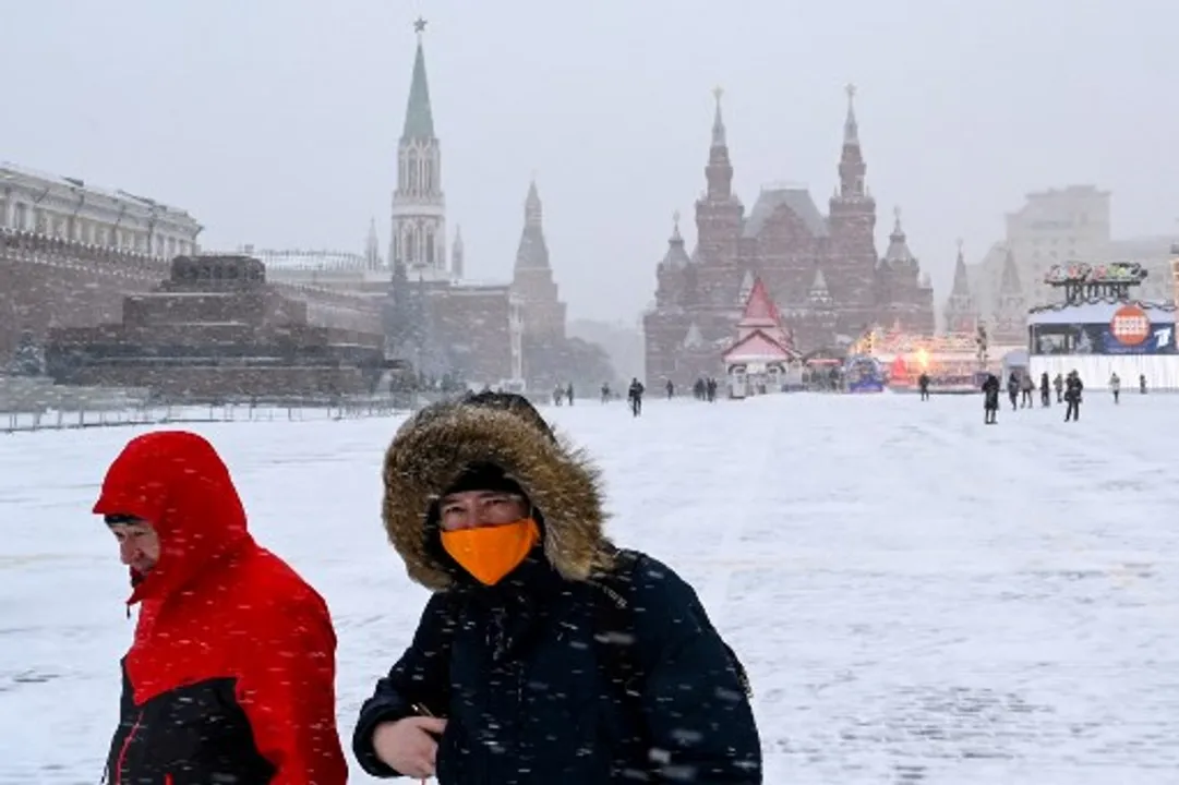  A man wearing a face mask walks on snow-covered Red Square in downtown Moscow Photograph:(AFP) 