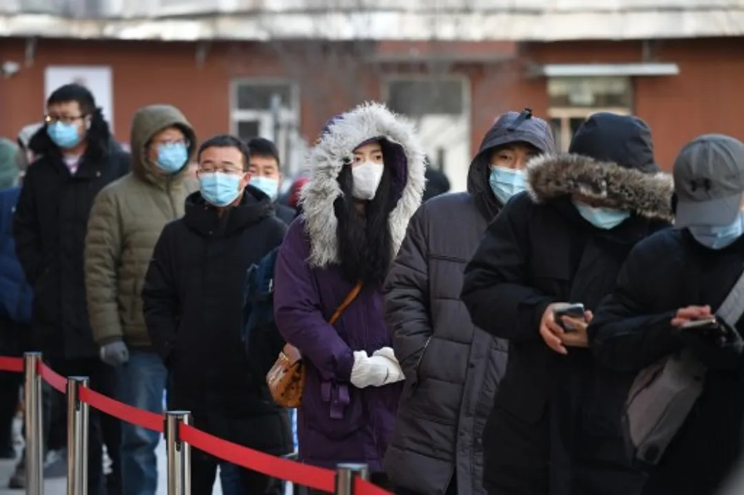  People line up to be tested for the COVID-19 coronavirus outside a hospital in Beijing  Photograph:(AFP) 