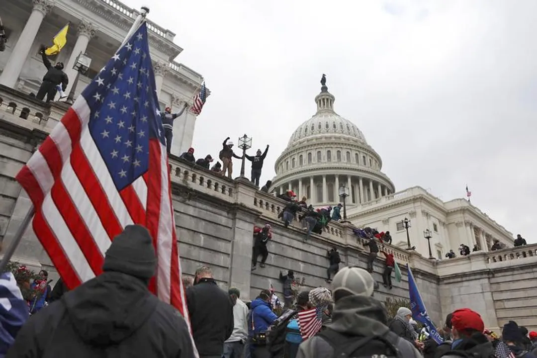  Supporters of President Trump scale the walls of the Capitol Building Photograph:(Reuters) 