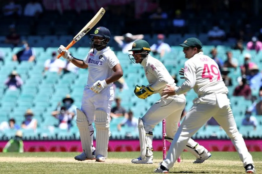  Australia's captain Tim Paine and Steven Smith celebrate the dismissal of India's Rishabh Pant during the fifth day of the third cricket Test match between Australia and India at the Sydney Cricket Ground Photograph:(AFP) 