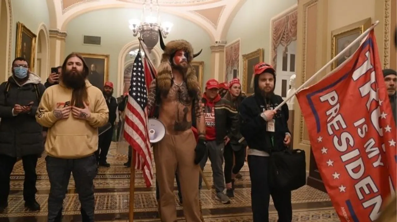  Supporters of US President Donald Trump, including member of the QAnon conspiracy group Jake Angeli, aka Yellowstone Wolf (C), enter the US Capitol on January 6, 2021, in Washington, DC. Demonstrators breeched security and entered the Capitol as Congress debated the a 2020 presidential election Electoral Vote Certification Photograph:(AFP) 