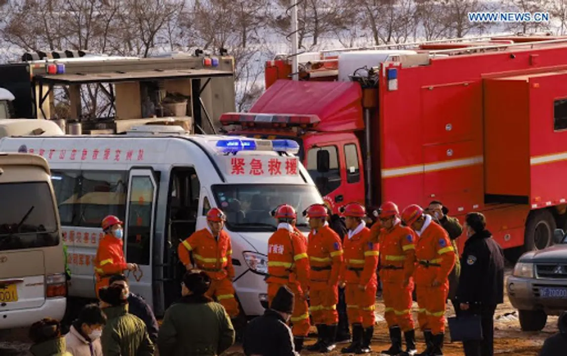 Chinese rescue workers outside a gold mine where workers are trapped underground following an explosion Photograph:(Reuters) 