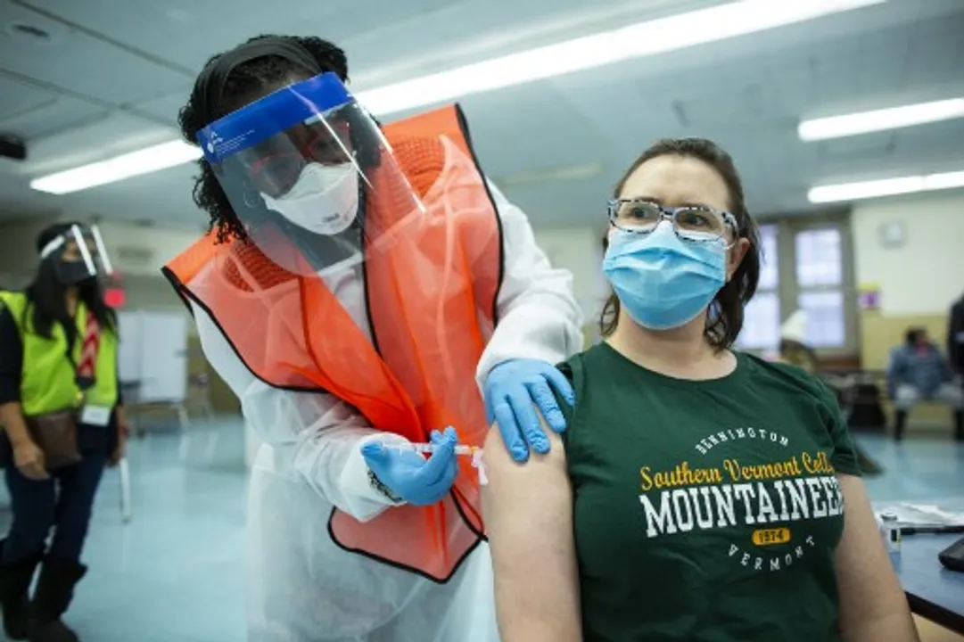  A nurse receives a dose of the Moderna coronavirus disease (COVID-19) vaccine at a vaccination site at South Bronx Educational Campus, in the Bronx New York  Photograph:(AFP) 