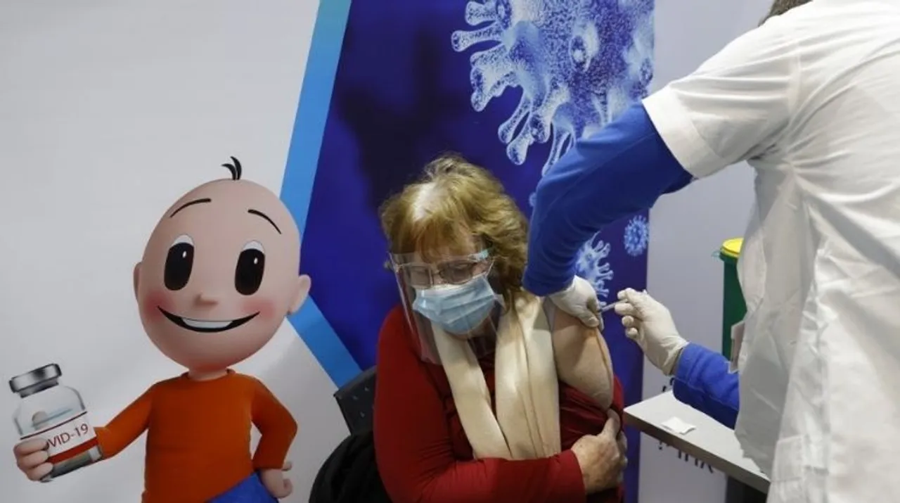  An Israeli health worker administers a dose of the Pfizer-BioNtech Covid-19 vaccine to a man at Clalit Health Services, in the hallways of the Netanya stadium, on January 20, 2021 in the Israeli coastal city of Netanya Photograph:(AFP) 