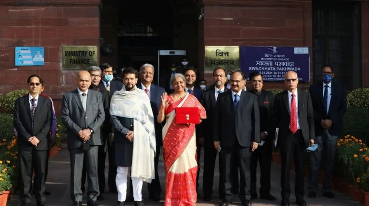  India's Finance Minister Nirmala Sitharaman (C) stands next to Minister of State for Finance and Corporate Affairs Anurag Thakur (3rd L) as she leaves her office to present the federal budget in the parliament in New Delhi, India, February 1, 202 Photograph:(Reuters) 