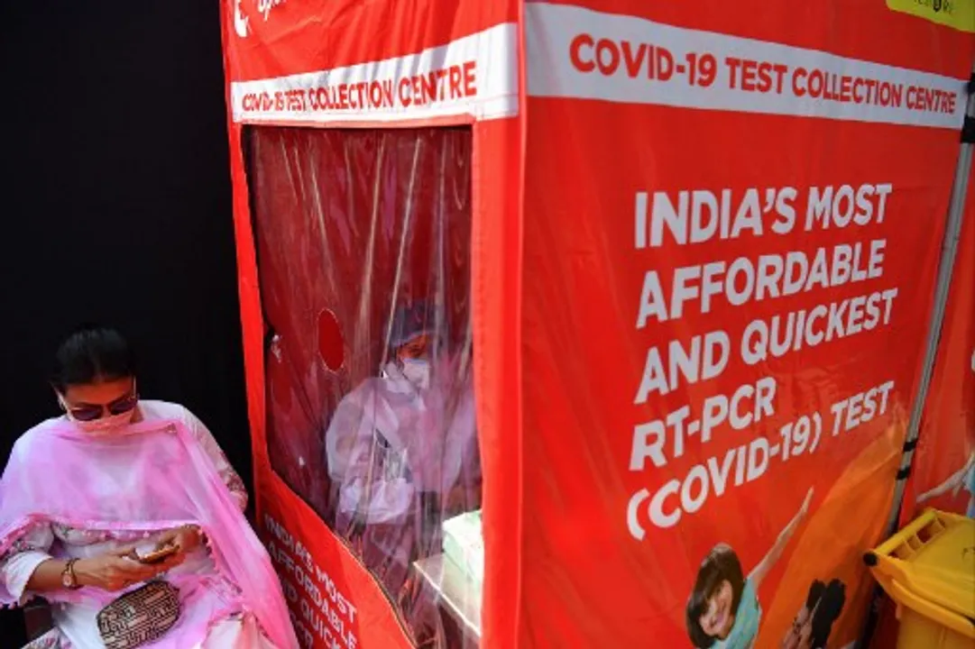  A health worker waits to take swab samples at a portable cabin of a mobile laboratory for conducting RT-PCR Covid-19 coronavirus tests in Mumbai  Photograph:(AFP) 