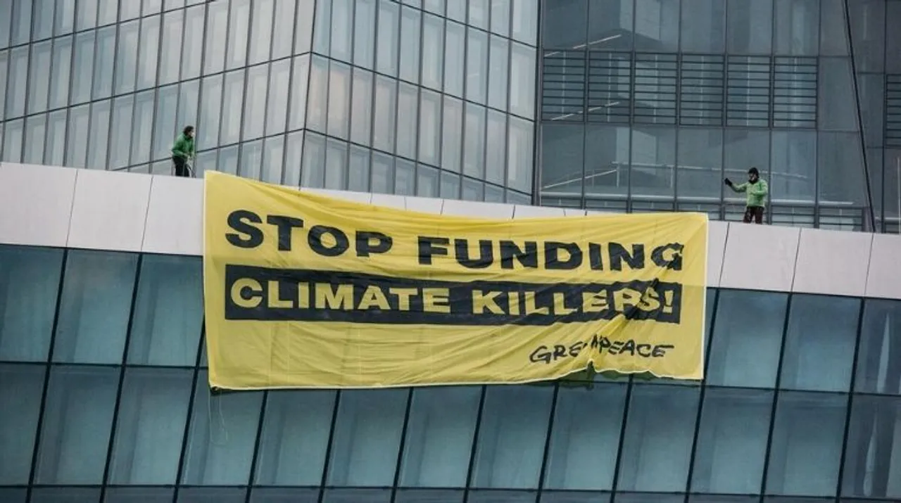  Two activists unfurl a banner that demands the ECB to 'stop funding climate killers'. (Picture Credit: Greenpeace) Photograph:(Others) 