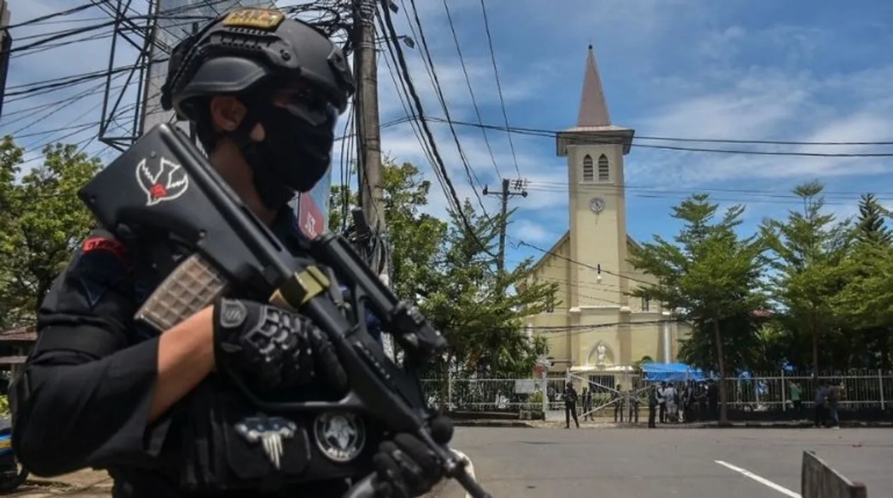  An Indonesian policeman stands guard outside a church after an explosion in Makassar on Sunday. Photograph:(AFP) 