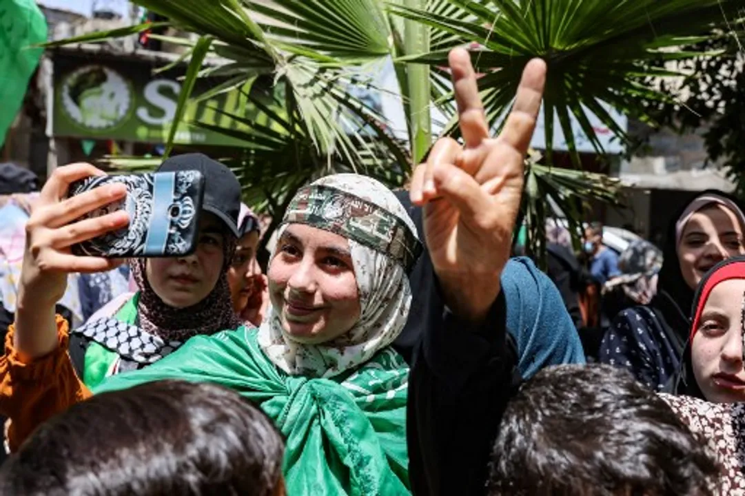  Palestinian supporters of the Hamas movement celebrate after a ceasefire brokered by Egypt between Hamas and IsraelÂ in southern Gaza Strip Photograph:(AFP) 