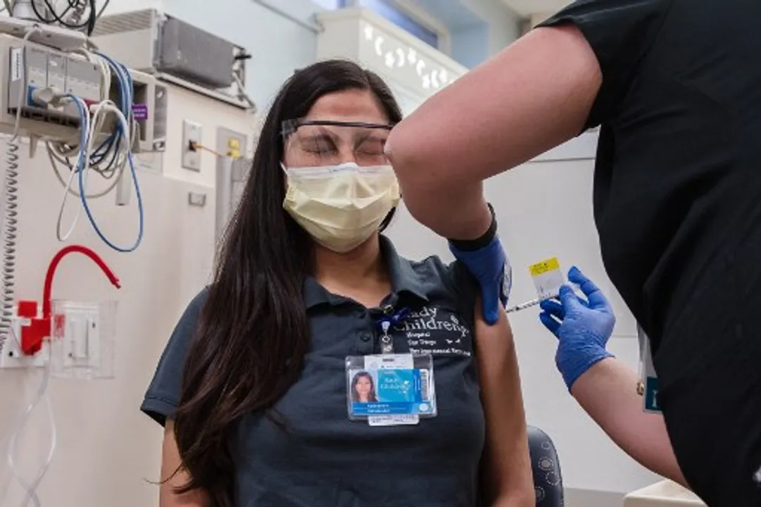  A health worker gives the Pfizer-BioNTech vaccine to a person in San Diego Photograph:(AFP) 