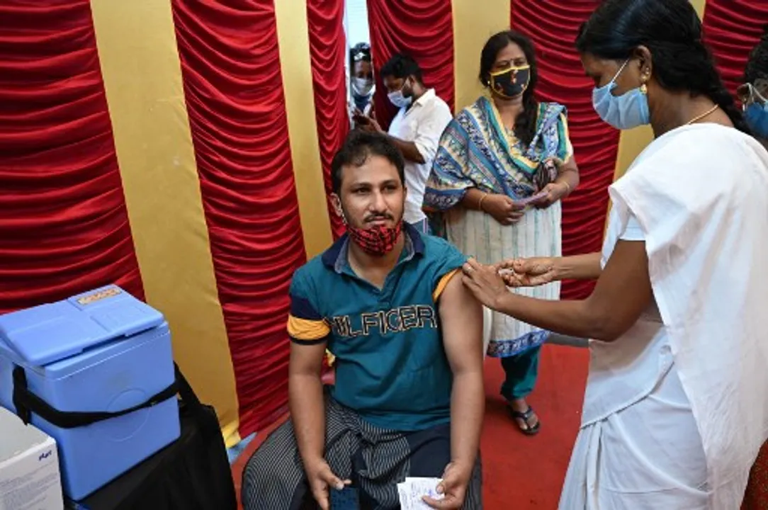 A health worker inoculates a man with a dose of the Covaxine vaccine at a vaccination camp in Chennai Photograph:(AFP) 