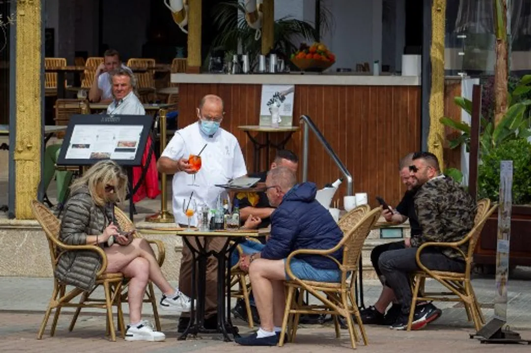 Tourists have drinks at a restaurant in Palma de Mallorca Photograph:(AFP) 
