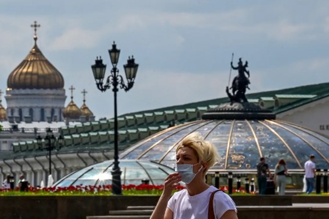  A woman wearing a face mask walks at Manezhnaya square in central Moscow Photograph:(AFP) 