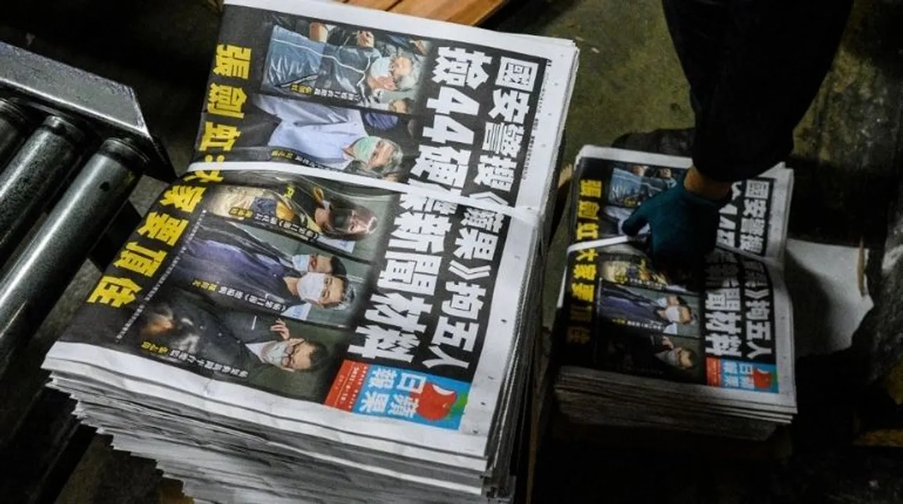  An employee stacks freshly printed papers onto a pallet in the printing facility of the Apple Daily newspaper offices in Hong Kong early on June 18, 2021. Photograph:(AFP) 