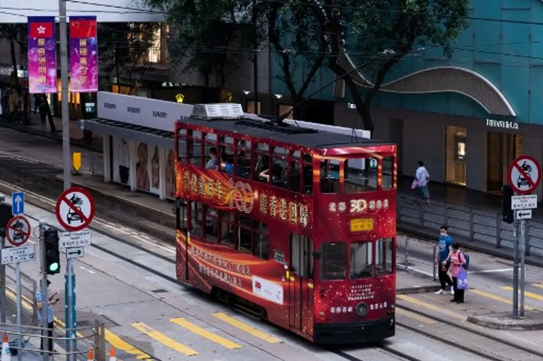  A themed tram with a slogan celebrating the 100th anniversary of the Chinese Communist Party and the 24th anniversary of Hong Kong's handover to China passes through a street in Hong Kong. Photograph:(AFP) 