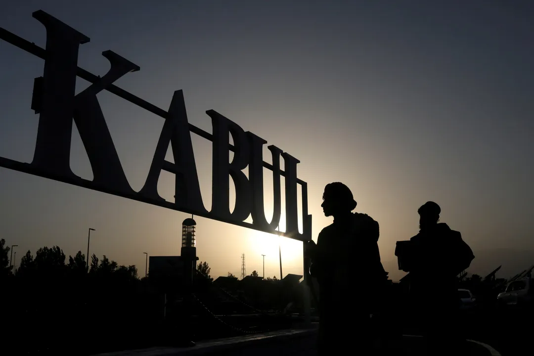  (File photo) Taliban soldiers stand in front of a sign at the international airport in Kabul Photograph:(Reuters) 