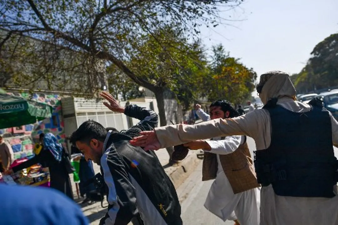  Taliban members (R) attack journalists covering a women's rights protest in Kabul on Thursday Photograph:(AFP) 