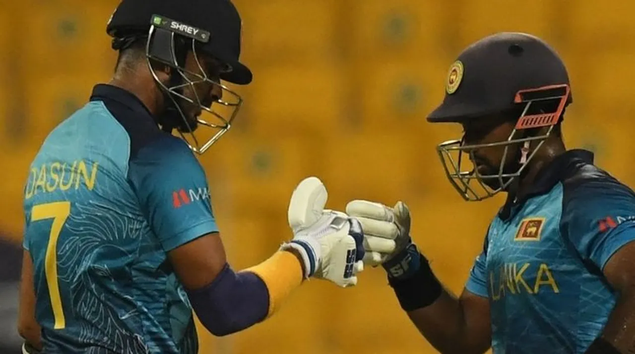  Sri Lanka's Charith Asalanka (R) bump fist with captain Dasun Shanaka (L)  Photograph:(AFP) 