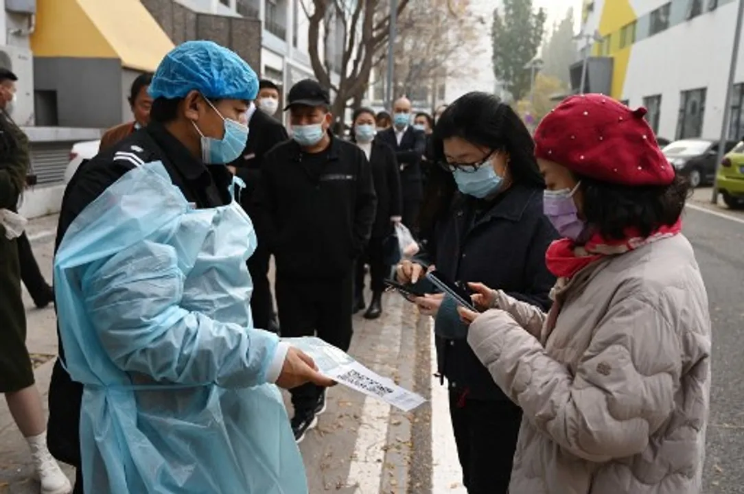  People scan a QR code to register before getting a Covid-19 coronavirus test in Beijing  Photograph:(AFP) 