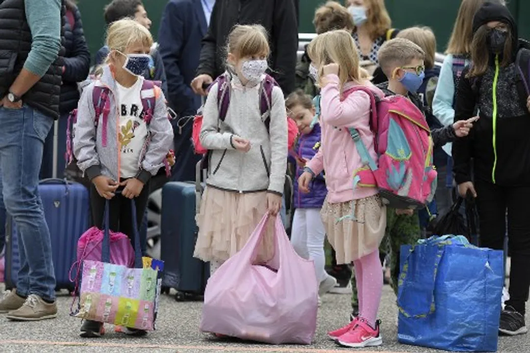  Pupils wearing masks wait before entering school in Strasbourg Photograph:(AFP) 