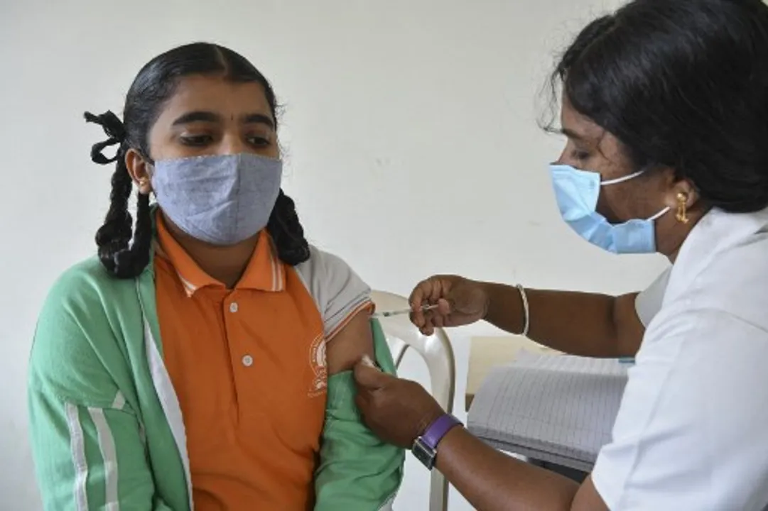  A health worker inoculates a college student in Karnataka Photograph:(AFP) 