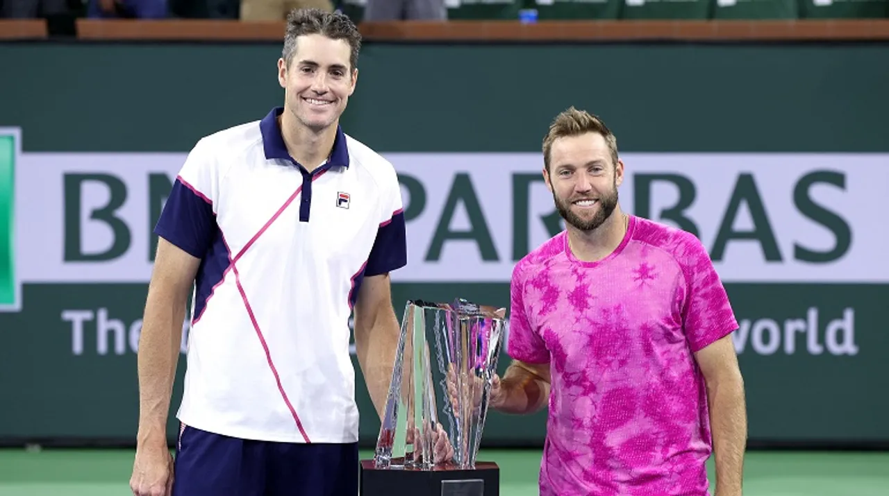  John Isner and Jack Sock pose for photographers after defeating Santiago Gonzalez and Edaouard Roger-Vasselin. Photograph:(AFP) 
