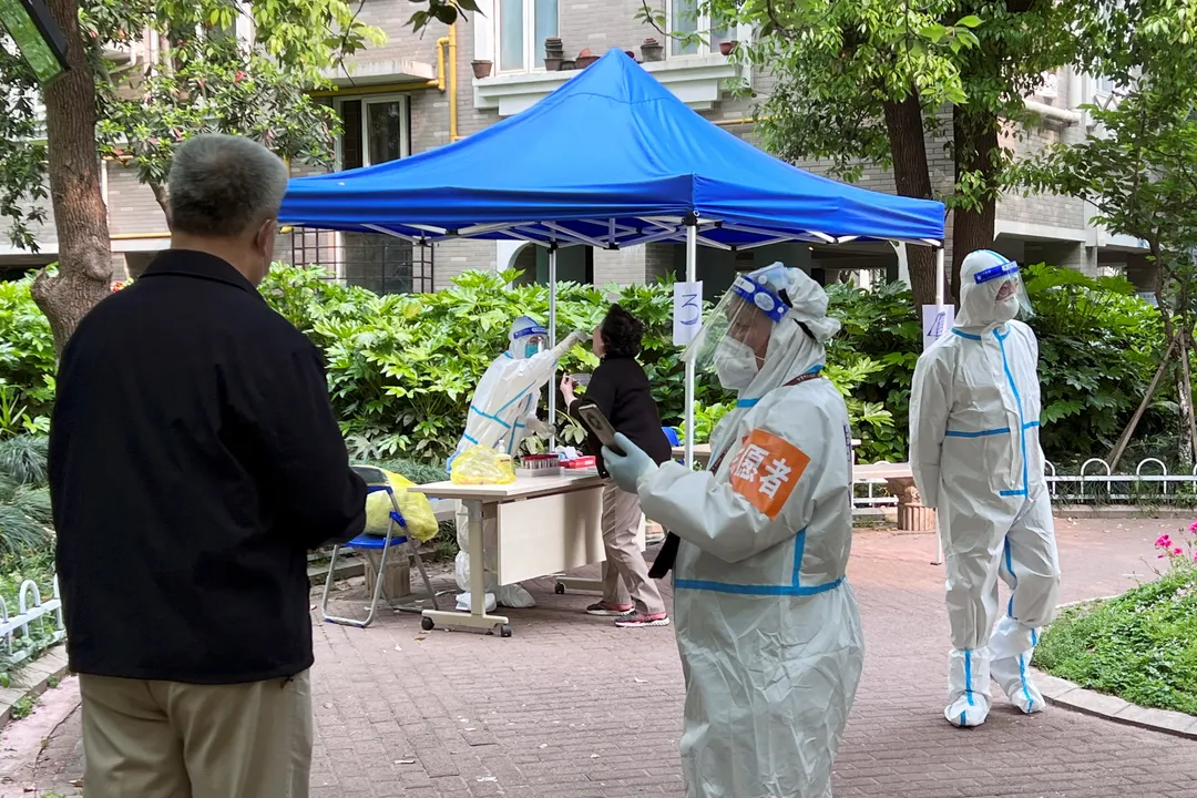  A health worker conductsÂ nucleic acid test against COVID-19Â Shanghai Photograph:(Reuters) 