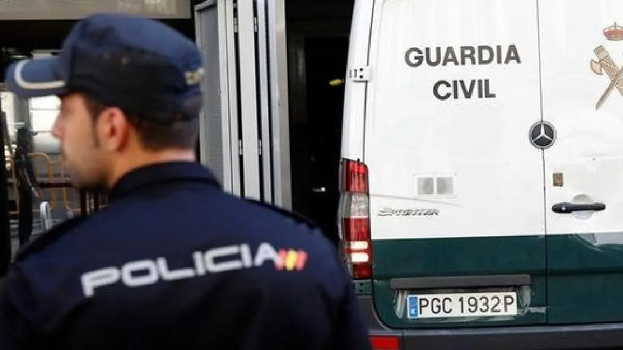  Spanish police officer and a police van  Photograph:(Reuters) 