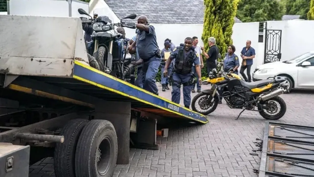  Authorities load seized motorcycles on a truck after the raid in Johannesburg. Photograph:(AFP) 