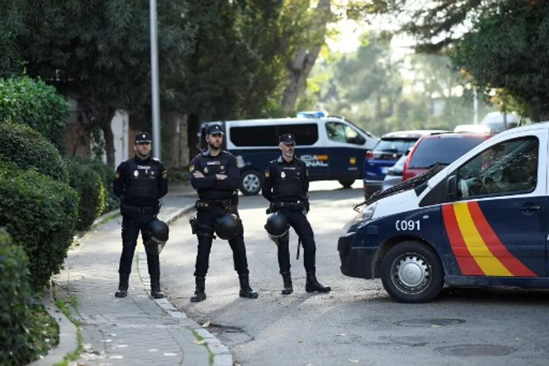  Spanish policemen block the street after a letter bomb explosion at Ukraine's embassy in Madrid  Photograph:(AFP) 