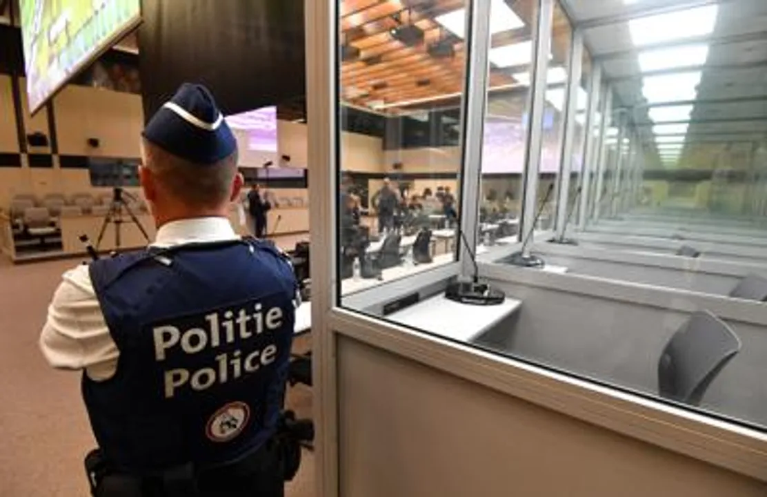  A police officer stands next to glass boxes for the defendants in the courtroom prior to the hearing, for the Brussels attacks that took place on March 22, 2016, Photograph:(AP) 