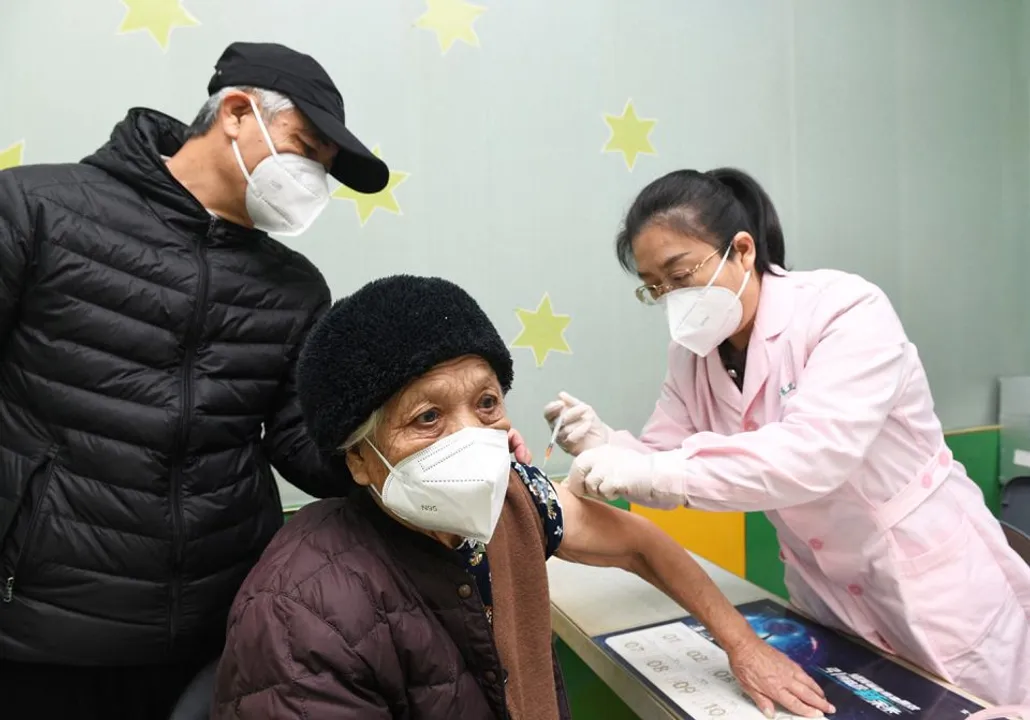  A medic administers a dose of the vaccine against COVID-19 to an elderly person at a community health service centre in Shijiazhuang, China Photograph:(Reuters) 